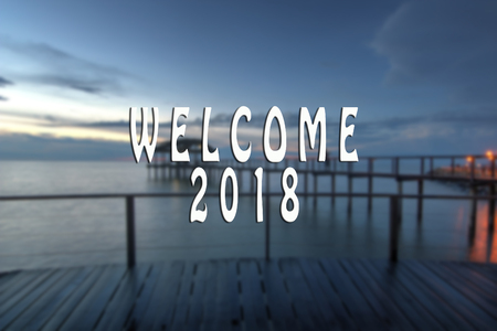 WELCOME 2018 text with the blurred landscape during sunset.の写真素材