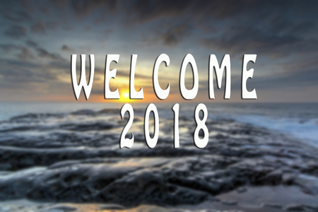 WELCOME 2018 text with the blurred landscape during sunset.の写真素材