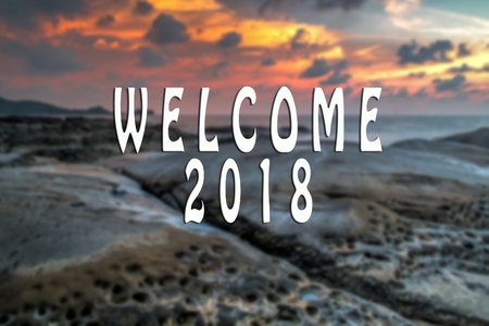 WELCOME 2018 text with the blurred landscape during sunset.の写真素材