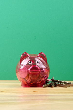 Piggy bank, small house and a bundle of house key. House saving conceptの写真素材