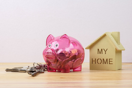 Piggy bank, small house and a bundle of house key. House saving conceptの写真素材