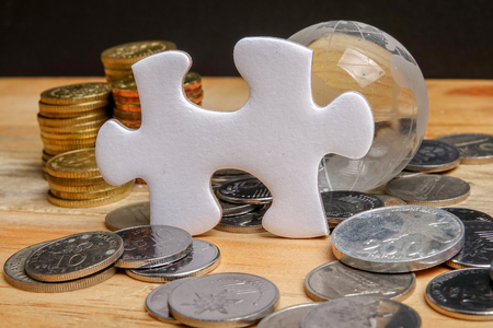 SAVING CONCEPT. Stack of coins on the wooden table over black background.の写真素材