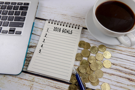 2018 GOAL CONCEPT: laptop and coins on wooden.の写真素材