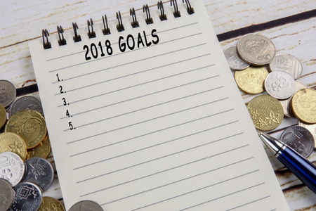 2018 GOAL CONCEPT: laptop and coins on wooden.の写真素材