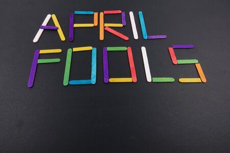 April Fools  background with colourful sticks on black backgroundの写真素材