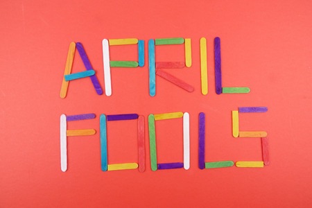 April Fools  background with colourful sticks on red backgroundの写真素材