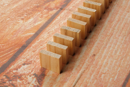 Domino effect isolated on wooden background