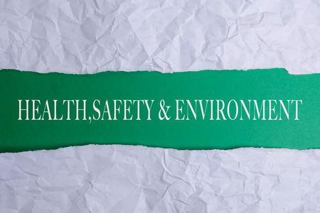 HEALTH, SAFETY AND ENVIRONMENT CONCEPT text at plain torn paper. の写真素材