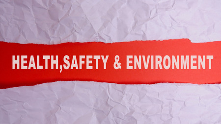 HEALTH, SAFETY AND ENVIRONMENT CONCEPT text at plain torn paper. の写真素材