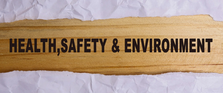 HEALTH, SAFETY AND ENVIRONMENT CONCEPT text at plain torn paper. の写真素材