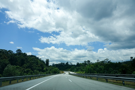 Empty road under blue sky with clouds at highway.の写真素材