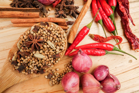 Mixture of beautiful spices and herbs on a wooden tableの写真素材