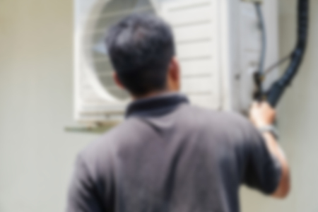 Blurred image of a  man repairing the  Air Conditioning Systemの写真素材