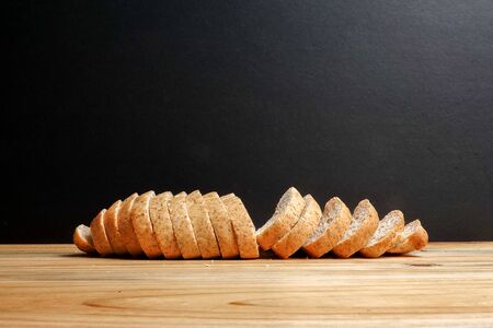 A loaf of wholegrain bread on a wooden backgroundの写真素材