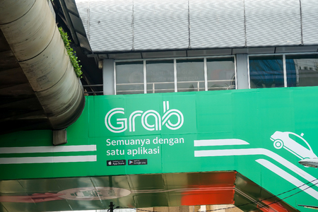KUALA LUMPUR, 20 APRIL 2018. Grab signage along the road in Kuala Lumpur. Grab is a easy and convenient e hailing services.のeditorial素材