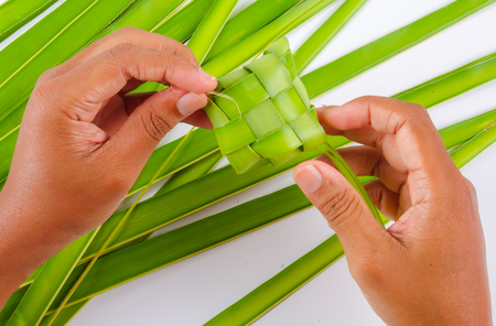 Making of Ketupat, a natural rice casing made from young coconut leaves for cooking riceの写真素材