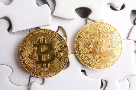 Bitcoins over white puzzle background. Copy Spaceの写真素材