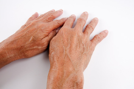 Pair of caucasian hands of senior middle aged male isolated against whiteの写真素材
