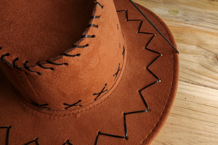 Cowboy hat on a wooden table. Side lighting effect and copy spaceの写真素材