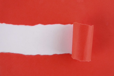 Red torn paper over white background. Copy spaceの写真素材