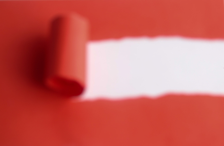 Red torn paper over white background. Copy spaceの写真素材