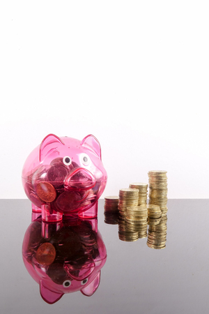 Saving Concept with coins stacked on a white background.の写真素材