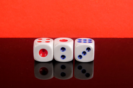 Stacked Dice on a red backgroundの写真素材