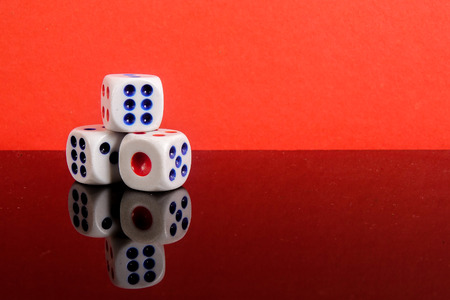 Stacked Dice on a red backgroundの写真素材