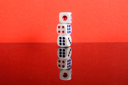 Stacked Dice on a red backgroundの写真素材