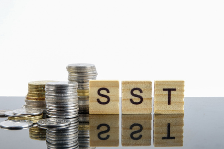 TAX CONCEPT. Sales & Service Tax word from wood plate and stacked of coins.の写真素材