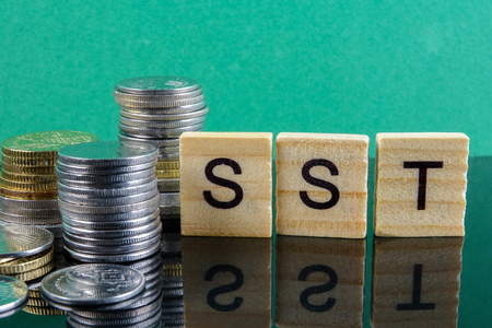 TAX CONCEPT. Sales & Service Tax word from wood plate and stacked of coins.の写真素材