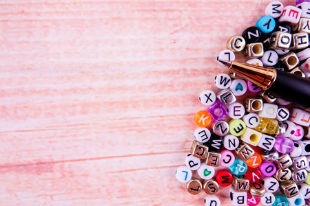 Colorful plastic alphabet dice on a wooden background as a background.の写真素材