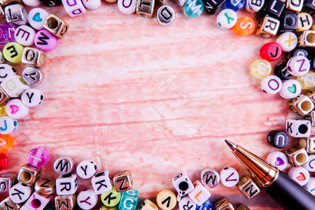 Colorful plastic alphabet dice on a wooden background as a background.の写真素材