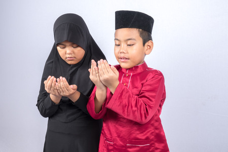 Potrait of young asian muslim boy/girl isolated on white background.