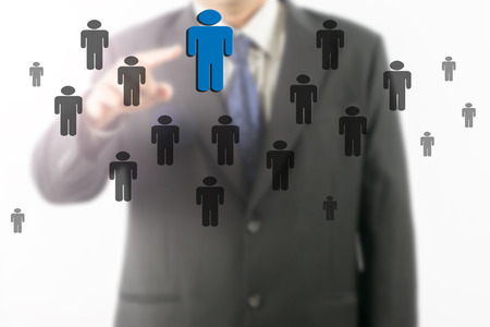 Blurred businessman hand is pointing the blue one on the transparent virtual screen.の写真素材