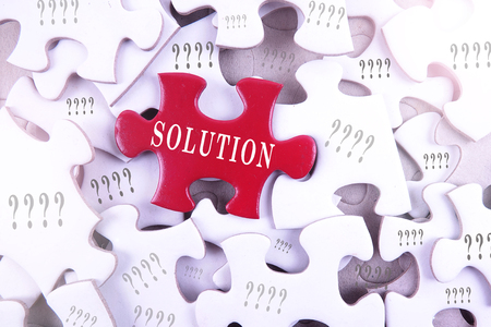 Solution concept, solution word on puzzle piece with question marks.の写真素材