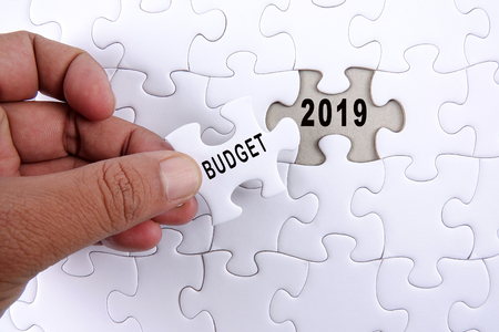 Business concept: 2019 BUDGET word on a jigsaw puzzle background.の写真素材
