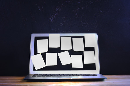 Reminders memo on a laptop screen over black rustic backgroundの写真素材