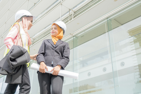 Professional woman engineers are discussing on construction at outdoor.の写真素材