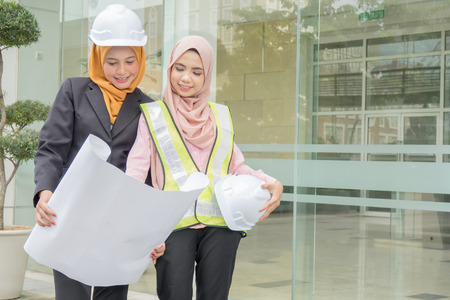 Professional woman engineers are discussing on construction at outdoor.の写真素材