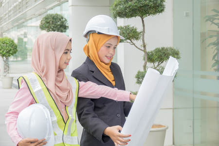 Professional woman engineers are discussing on construction at outdoor.の写真素材