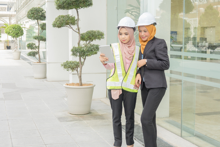 Professional woman engineers are discussing on construction at outdoor.の写真素材