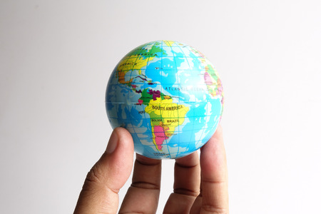 World globe  on a palm over a white. Globalization Conceptの写真素材