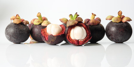 Mangosteen, an exotic asian fruit isolated on white with reflection.の写真素材