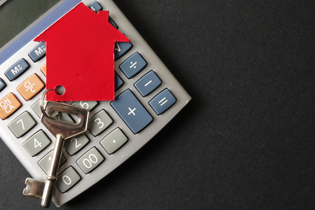 Property/housing ownership concept with red small house and steel key.の写真素材