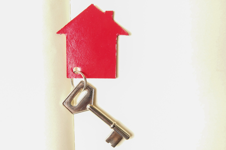 Property/housing ownership concept with red small house and steel key.の写真素材