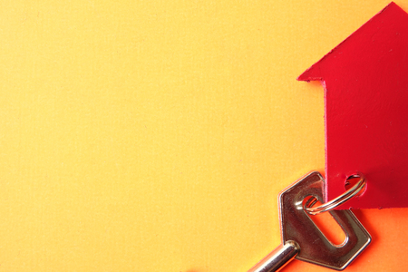 Property/housing ownership concept with red small house and steel key.の写真素材