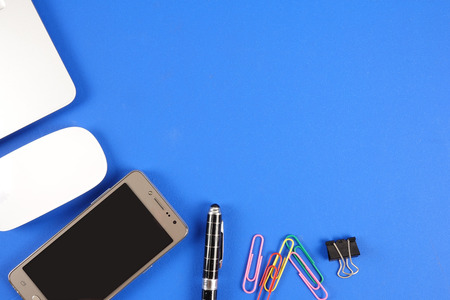 Top view of office staioneries over blue background.の写真素材