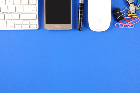 Top view of office staioneries over blue background.の写真素材