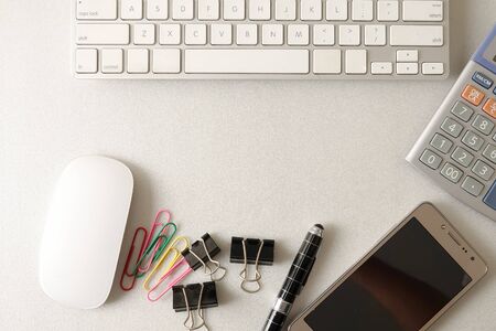Top view of office stationeries over a grey background.の写真素材
